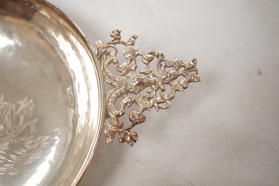 A pair of George V continental silver quaichs, with pierced lug handles and each engraved with a three-masted ship at sea, import marks for Berthold Hermann Muller, London, 1913, 17.3cm.